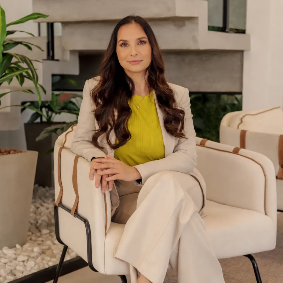 Angélica Flores sentada em ambiente reservado de atendimento